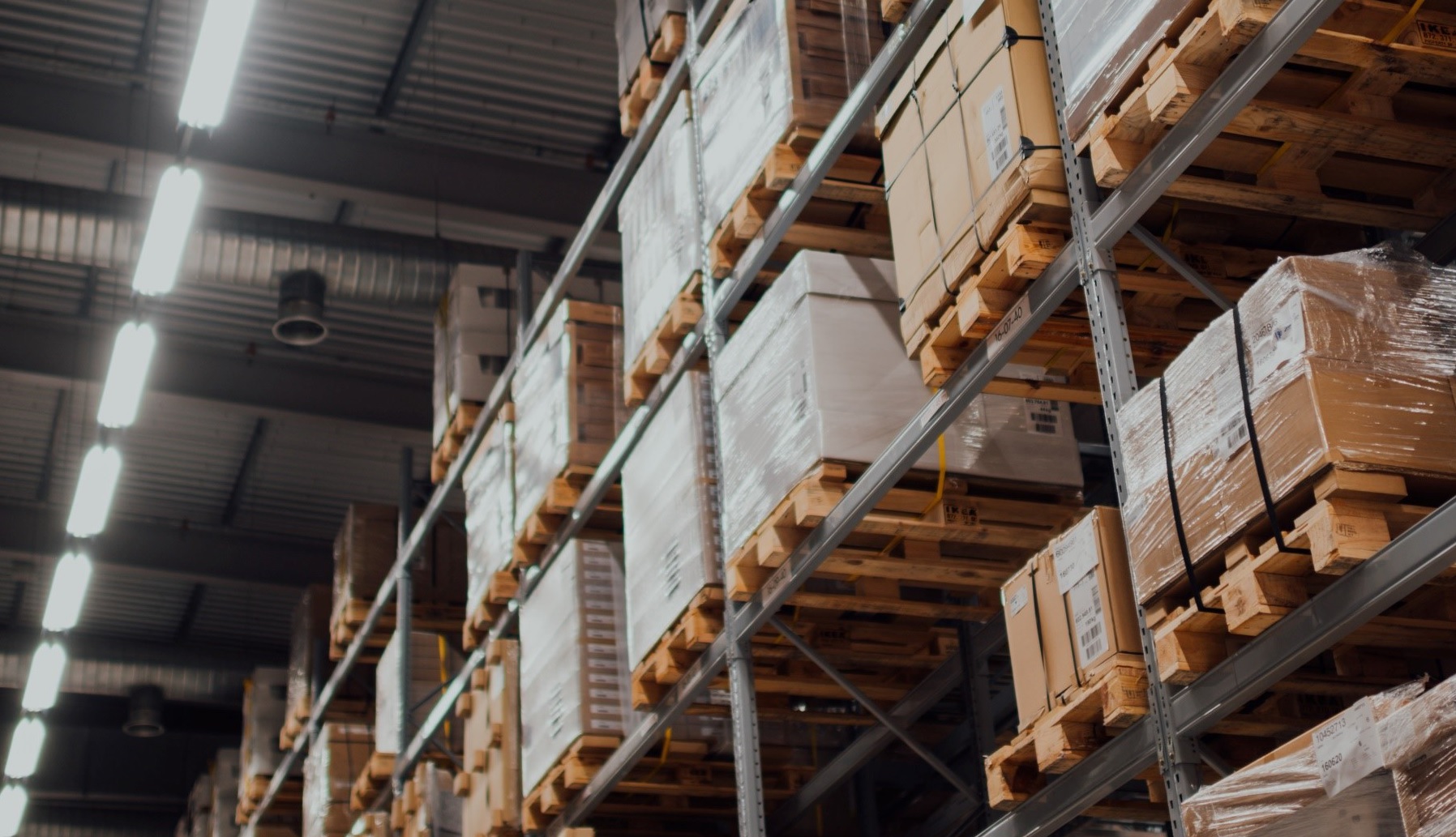 storage warehouse with pallets of boxes stacked on racks