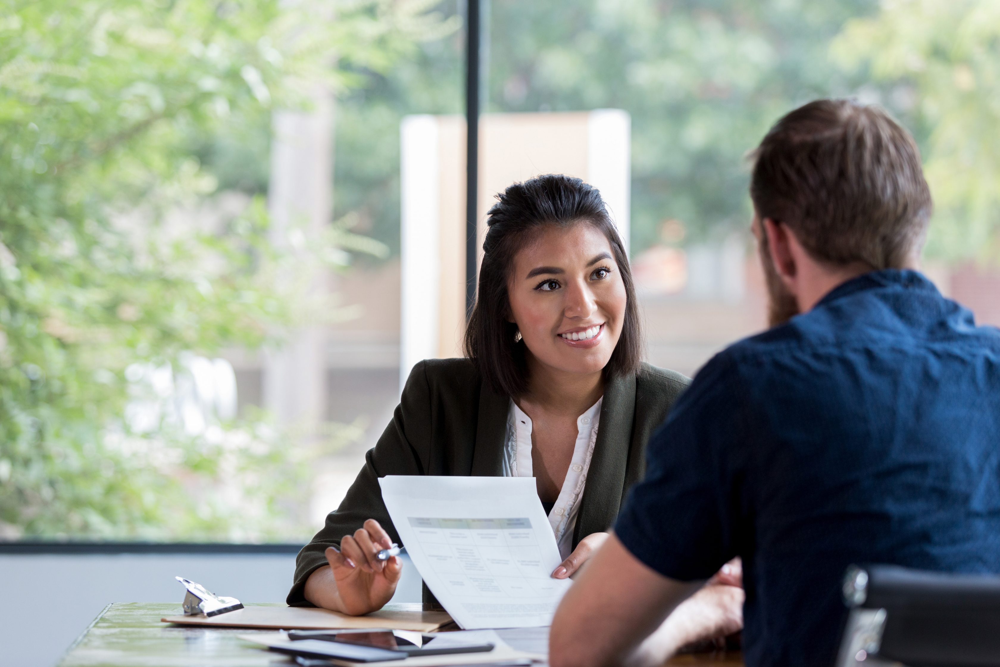 two colleagues talking in office